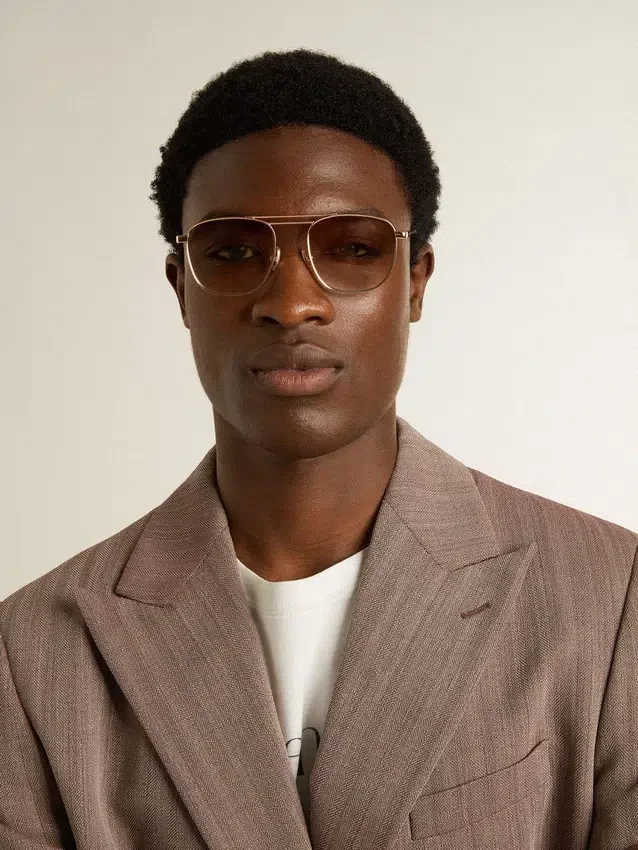 Aviator-style sunglasses with gold frame and beige lenses