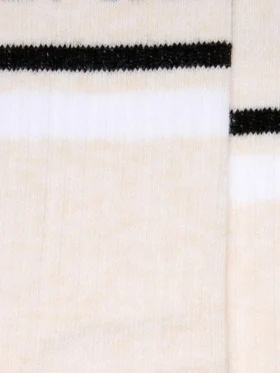 Blush-colored socks with distressed details and black and white stripes