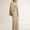 Women's beige pinstripe single-breasted jacket with an oversized fit