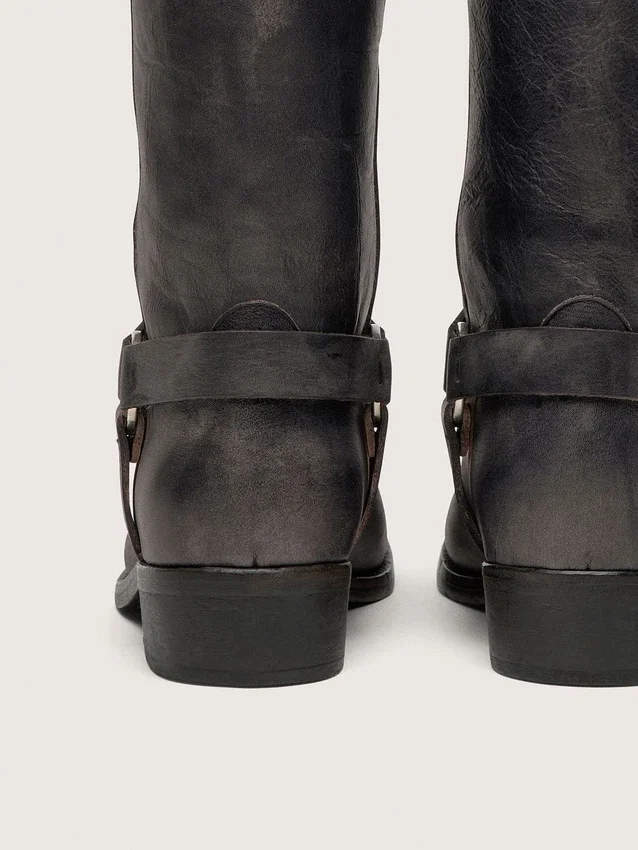 Women's high Biker boots in black leather with strap and silver-colored buckle