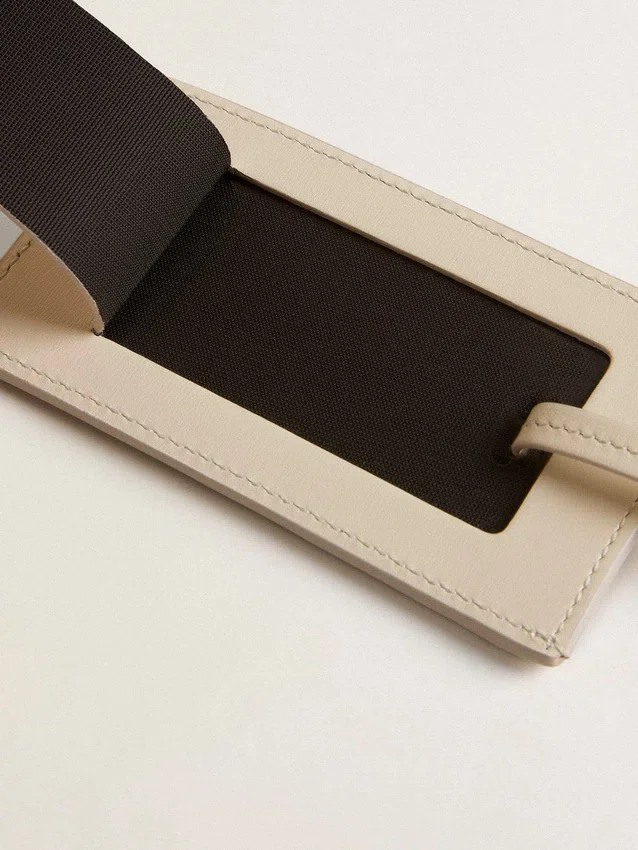 Worn white luggage tag